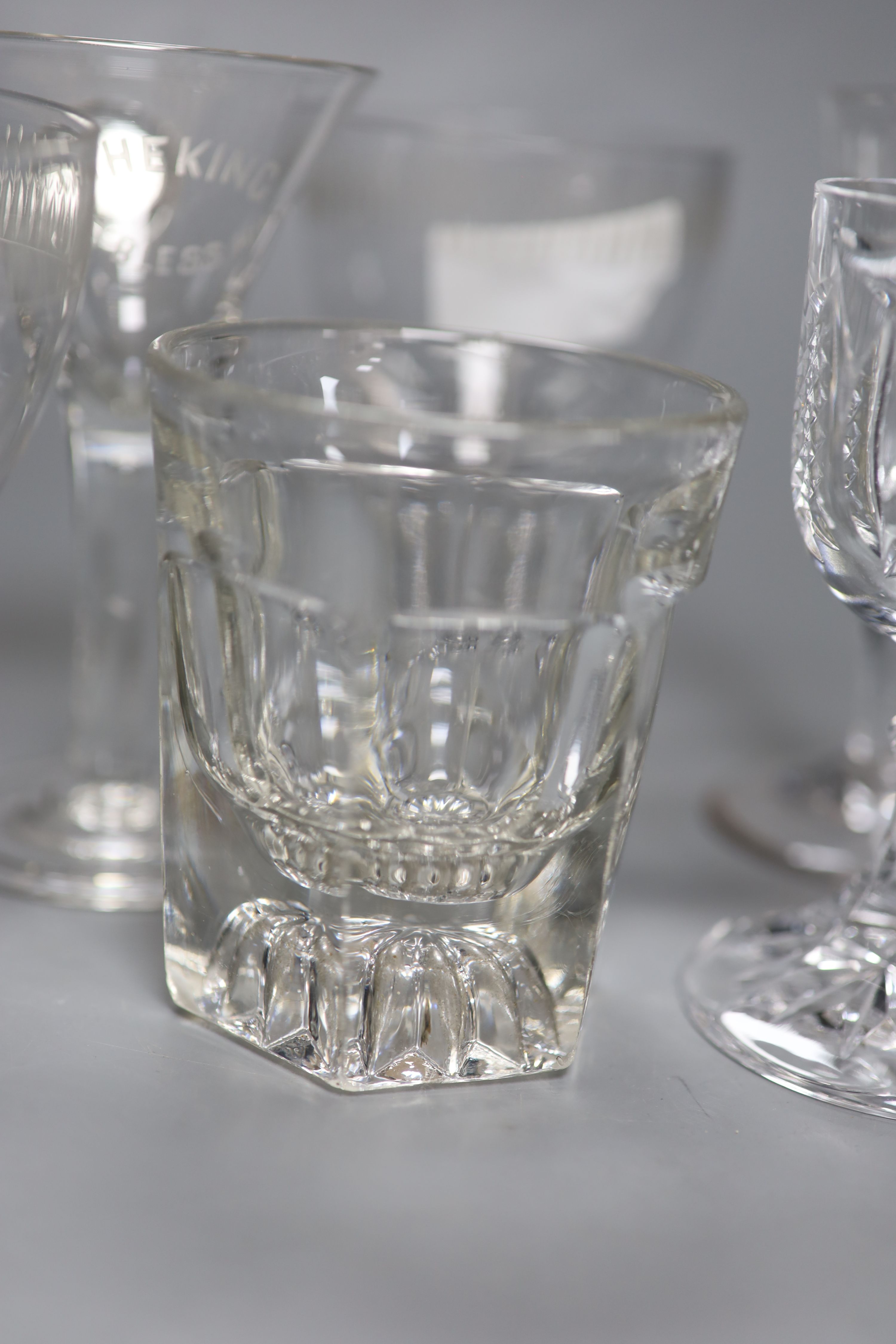 A pair of square base glasses and four others